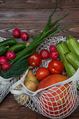 Healthy food vegetables in Eco-friendly packaging reusable bag on wooden table background.