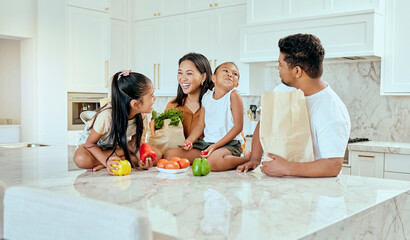 Asian, family and vegetables in kitchen for laugh at table, happy or comic in bonding. Mom, dad and children with smile at counter for funny, joke or crazy with bags after shopping in home in Jakarta - obrazy, fototapety, plakaty