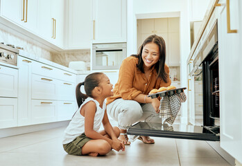 Asian, mom and girl in kitchen at oven, baking and cupcakes with stove, happy and home. Mother,...