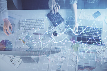 Multi exposure of man and woman working together and financial chart hologram. Business concept. Computer background.