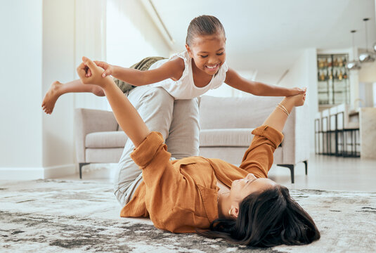 Mother, girl love and playing airplane fly in air bonding activity together in the house living room. Happy mom, excited laugh child or kid and fun game spend quality time on floor at family home