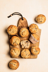Chocolate banana muffins on a wooden board, top view