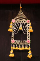 Thai style hanging fresh flowers art on window call 'ta khai na chang'