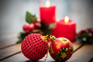 christmas balls with candles in the background. merry christmas and happy new year concept