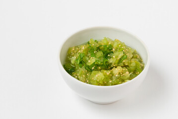 Physalis or tomatillo dip in ceramic bowl isolated on white background. Vegetable salsa verde sauce