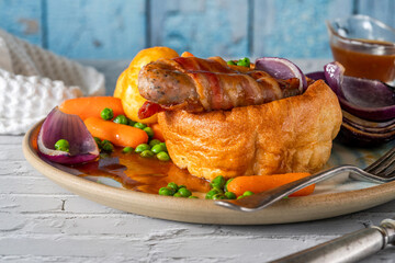 Toad in the hole with Yorkshire pudding, sausages and vegetables