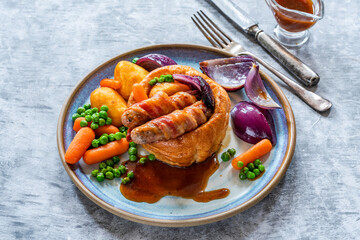 Toad in the hole with Yorkshire pudding, sausages and vegetables