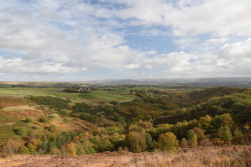 Naklejka premium Countryside views from the top of a mountain with rural farmland and far reaching views. Taken in Bury Lancashire England. 