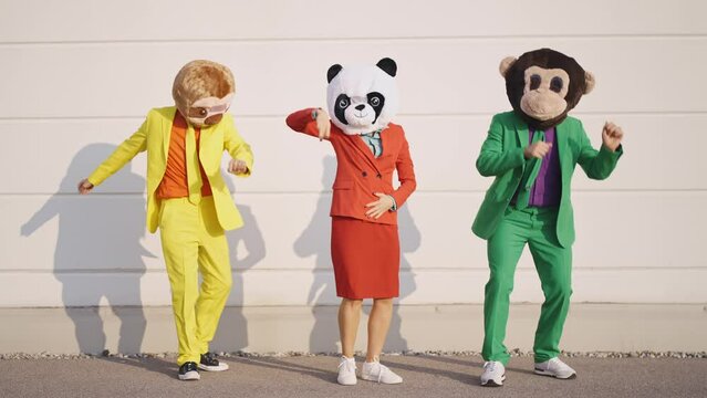 cinematic and storytelling video of a group of friends having fun and celebrating outdoor wearing funny mascots costumes