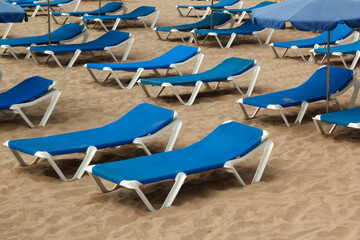 Beach sunbeds on sand