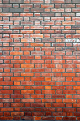 Mur de briques,  couleurs en dégradé du gris au rouge foncé, joints foncés