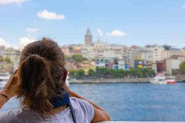 Fototapeta na wymiar Travel to Istanbul background photo. Tourist woman looking to the Galata Tower