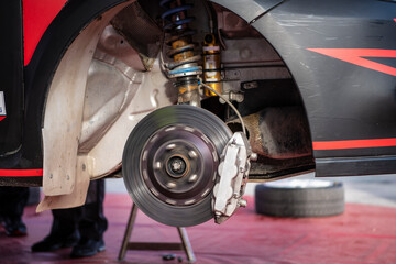 Closeup of steel brake rotating disc in car service. Concept for replacing wheel pads in garage....