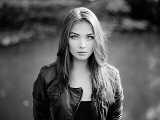 Portrait of young beautiful woman in leather jacket. Fashion photo