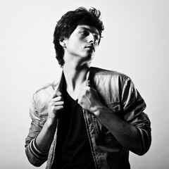 Portrait of a young handsome man in a denim jacket. Fashion photography