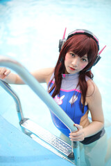 Portrait of Japan anime cosplay girl with swim suit at swimming pool