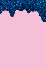 Shiny border made of glitter gel on a colored background. Christmas background with copy space