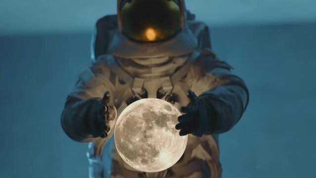 Close up of and astronaut in space suit holding and dropping the moon Dark sci-fi interior. 3D animation. 