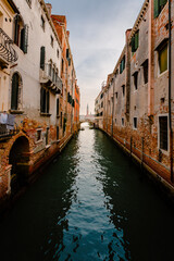 Venice canal with bridge and bell tower in the background