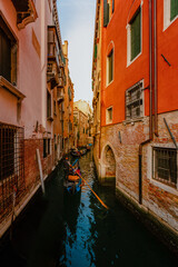 Fototapeta na wymiar Gondolas as they sail through Venice's characteristic canal