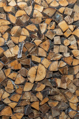Woodpile with firewood. Preparation for the winter stove heating. Close-up. Vertical.