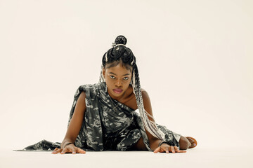 a girl in a black dress with a pattern on a white background