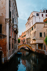 Fototapeta na wymiar Glimpse with characteristic bridge in the historic center of the lagoon city of Venice