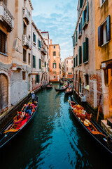 Fototapeta na wymiar Typical Venetian canal crowded with gondolas crossing it