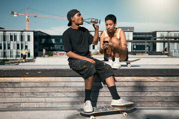 Skateboard, drinking water and friends with a black man and woman skater outdoor in a city for fun...