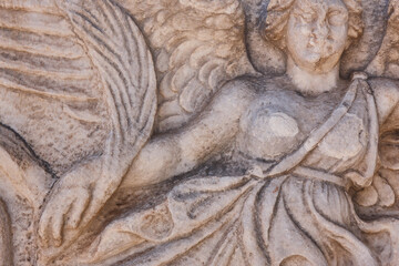 Ancient winged woman sculpture on a marble stone in Ephesus