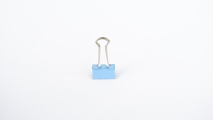 A binder clip is a strip of spring steel bent into the shape of an isosceles triangle with loops at the apex. This tool is used to clamp paper to make it neater
