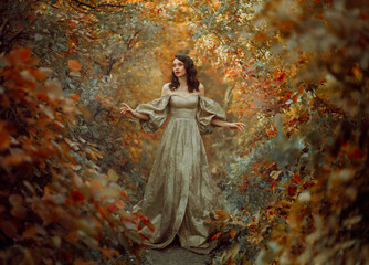 Queen fantasy woman walks in path mystical autumn forest. Orange Gold red foliage fairy tale...