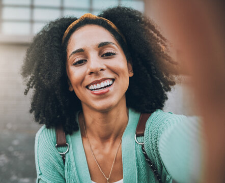 Selfie, travel and happy with a black woman tourist in the city for sightseeing or exploring outdoor. Street, face and portrait with a young female traveler taking a photograph in an urban town