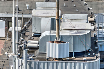 Ducts, pipes, lightning rods and other equipment on the roof of an office building - obrazy, fototapety, plakaty