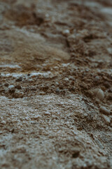 Fototapeta na wymiar Dry stone ground in brown color, soft focus