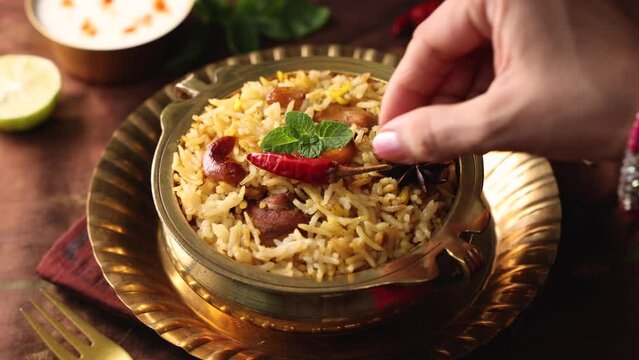 Chicken biryani Spicy Indian Malabar biryani Hyderabadi biryani, Dum Biriyani pulao golden bowl Kerala India Sri Lanka Pakistan basmati rice mixed rice dish with meat curry Ramadan Kareem, Eid
