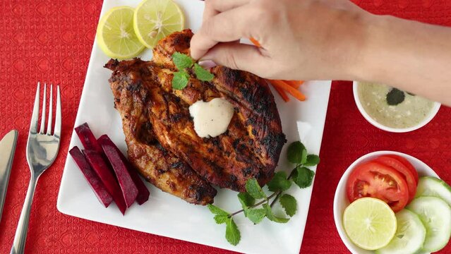 Alfaham Chicken , Arabian spicy food tandoori whole chicken Bengaluru, India . Platter served with salads. Al Faham Charcoal Grilled Chicken in India . 4k video footage.