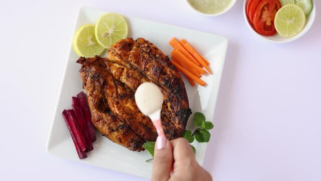 Alfaham Chicken , Arabian spicy food tandoori whole chicken Bengaluru, India . Platter served with salads. Al Faham Charcoal Grilled Chicken in India . 4k video footage.