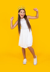 happy teen kid in crown on yellow background