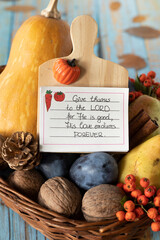Thanksgiving day card with handwritten text for giving thanks to the LORD in a wicker basket with...