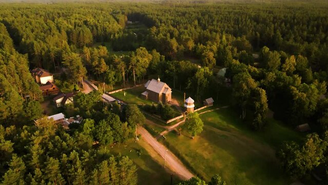Aerial view of a historic old wooden church in the rural countryside of Salakas, in Paluse vilage, in Lithuania