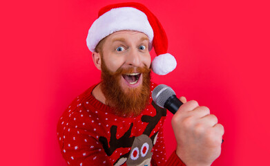 christmas music party. surprised man at christmas music party with microphone. christmas santa man
