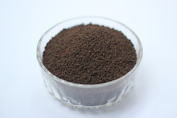 Dry black tea leaves decorated on white background