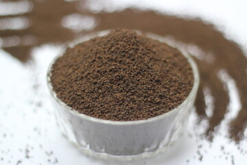 Dry black tea leaves decorated on white background