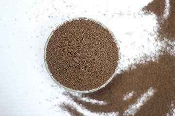 Dry black tea leaves decorated on white background