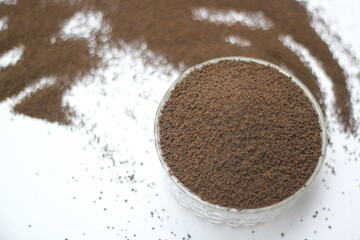 Dry black tea leaves decorated on white background