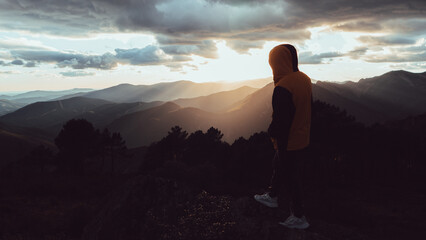 A person watching a spectacular sunset in the mountains