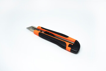 Closeup view of orange cardboard cutter isolated on white background. Box cutter isolated