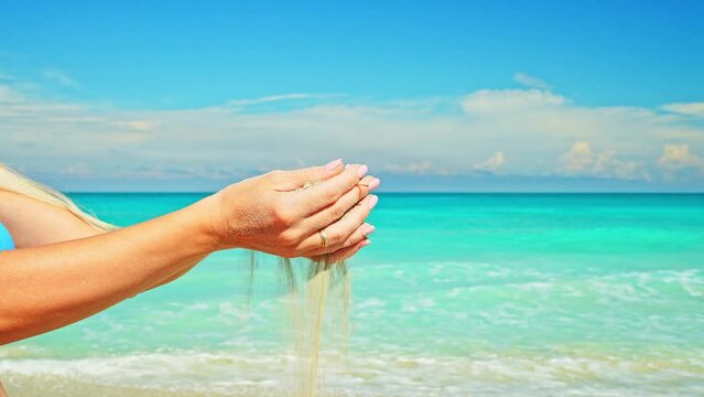 Sand Grains Run Through Female Hands. Woman Holding and Releasing Sand Through Fingers. Irreversible Flow of Time. Loss and Inconvertibility.