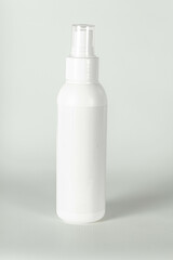 White plastic bottle for spraying on a light gray background. Vector template for advertising, cosmetic or chemical products.